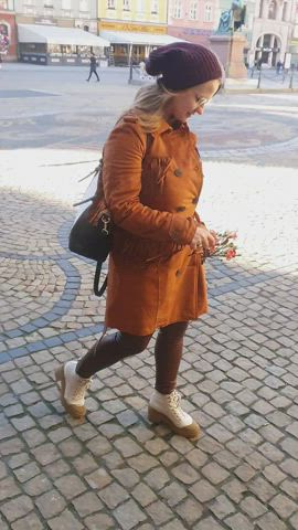 And such an ordinary walk of a modest girl with flowers in the old town square. [GIF]