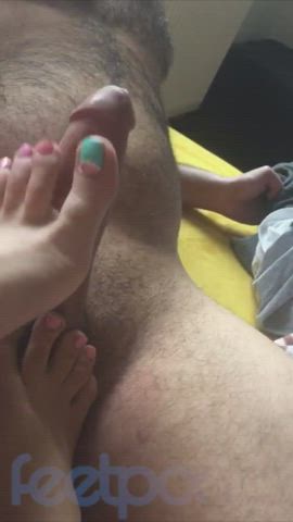 girl with green and pink toes gives footjob
